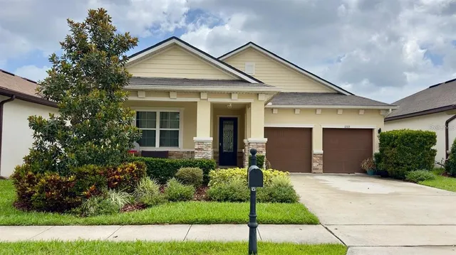 a front view of a house with a yard and garage