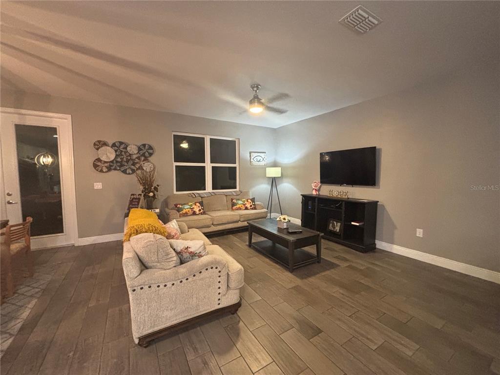 1222 Yorkshire Court Davenport, FL 33896 - Photo 12 of 17 a living room with furniture and a flat screen tv