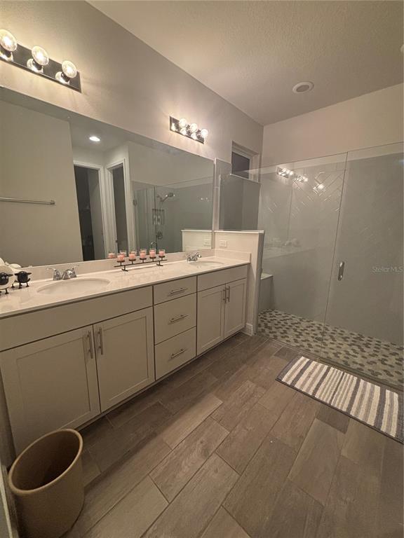 1222 Yorkshire Court Davenport, FL 33896 - Photo 13 of 17 a bathroom with a double vanity sink a toilet and a mirror