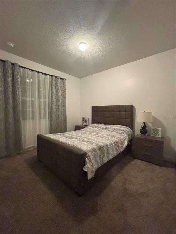 1222 Yorkshire Court Davenport, FL 33896 - Photo 2 of 17 a bedroom with a bed and a window