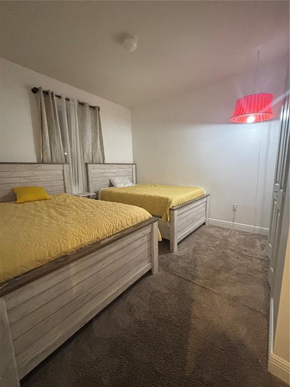 1222 Yorkshire Court Davenport, FL 33896 - Photo 3 of 17 a bedroom with a bed and a dresser