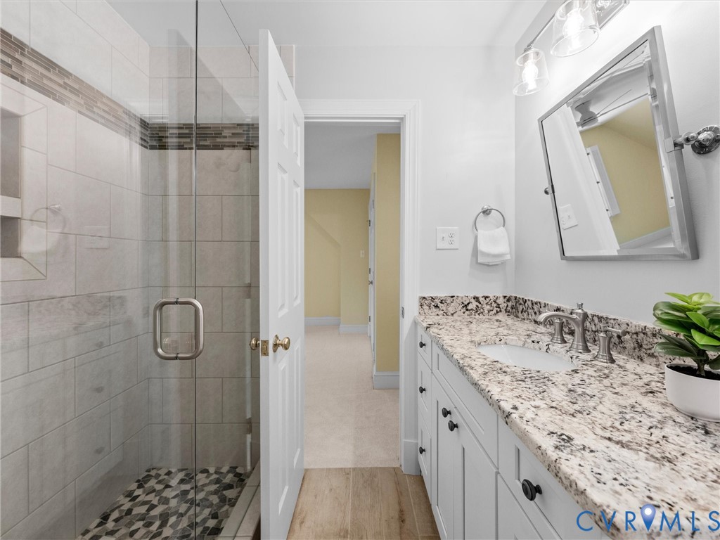 2011 Gamelaw Court Midlothian, VA 23113 - Photo 47 of 77 a bathroom with a granite countertop sink a mirror a vanity and shower
