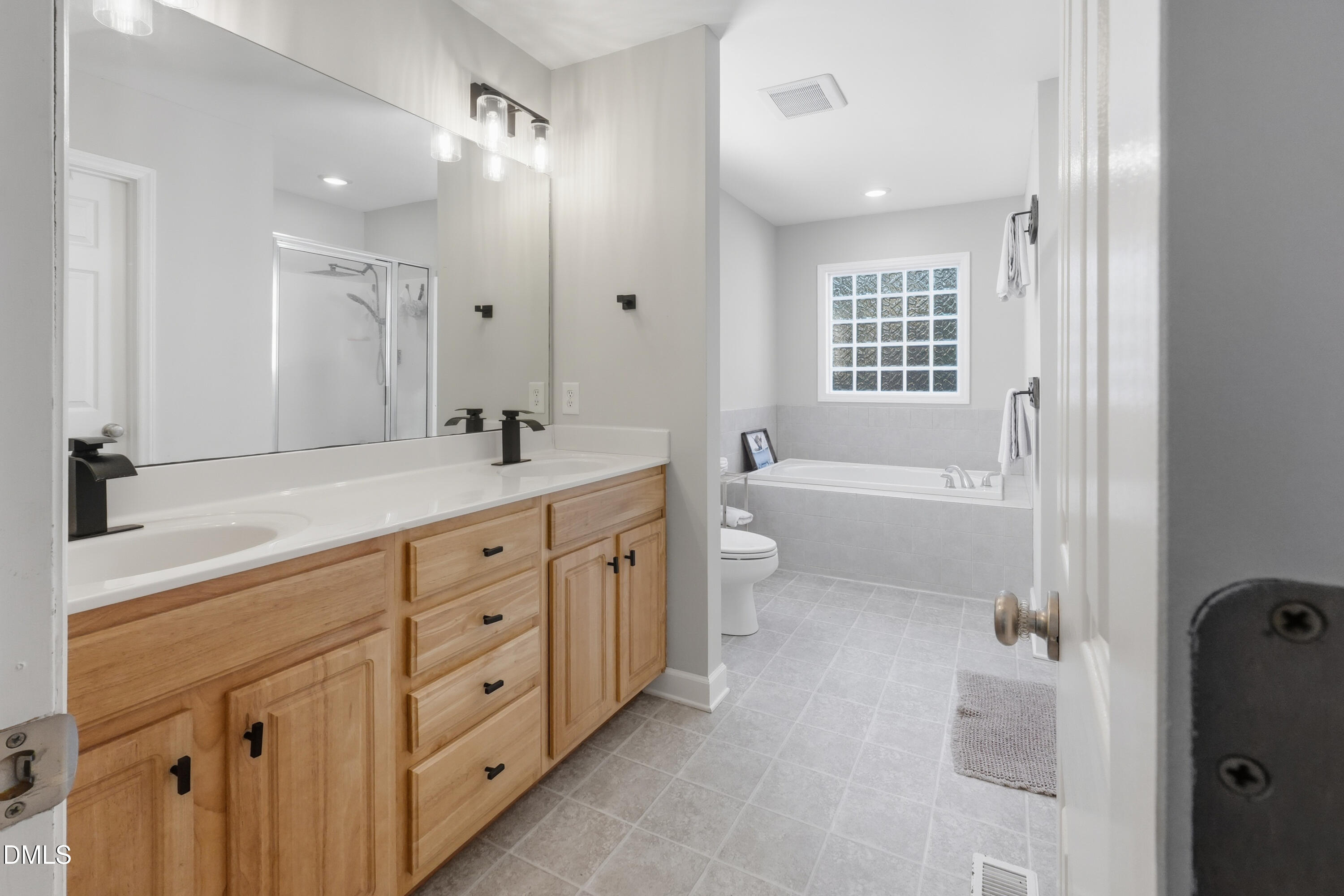 2097 Satterwhite Road Oxford, NC 27565 - Photo 17 of 40 a spacious bathroom with a double vanity sink a toilet and a bathtub