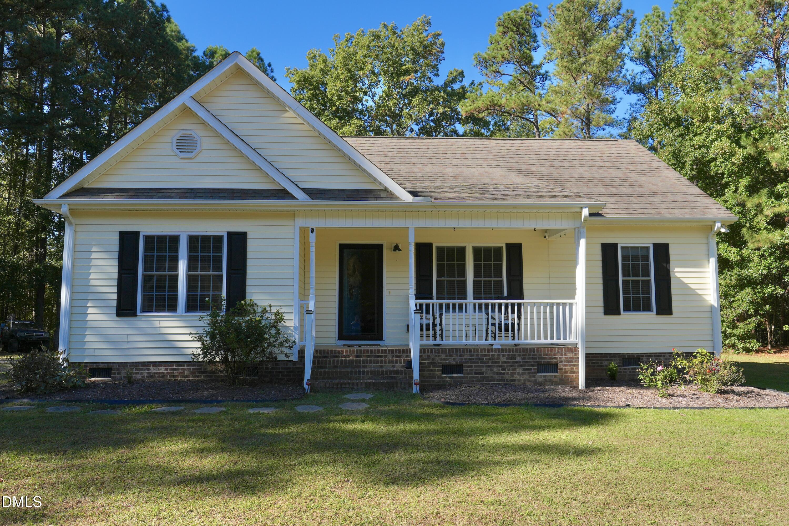 2097 Satterwhite Road Oxford, NC 27565 - Photo 2 of 40 a front view of a house with a garden and swimming pool