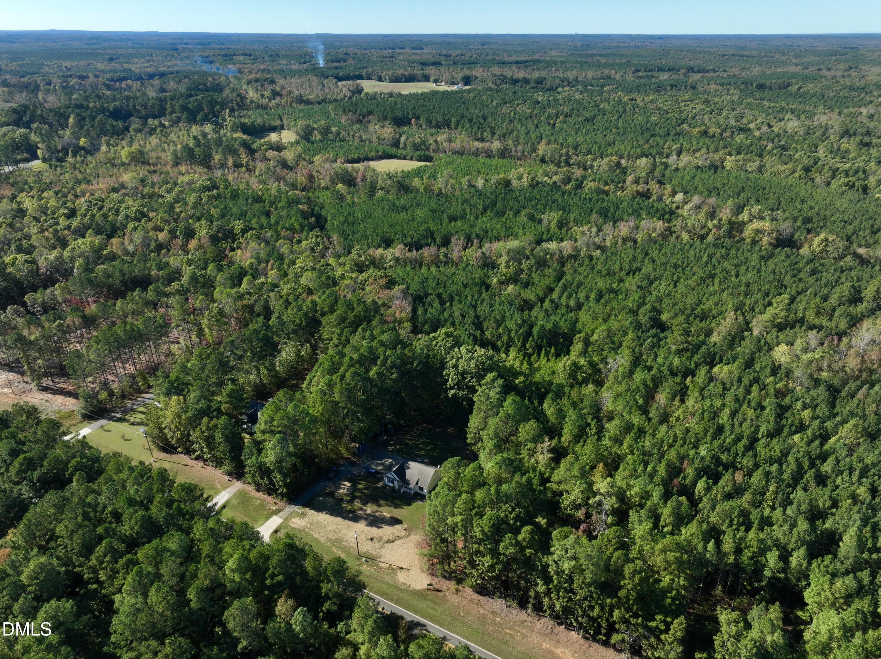 2097 Satterwhite Road Oxford, NC 27565 - Photo 32 of 40 a view of a green field with lots of bushes