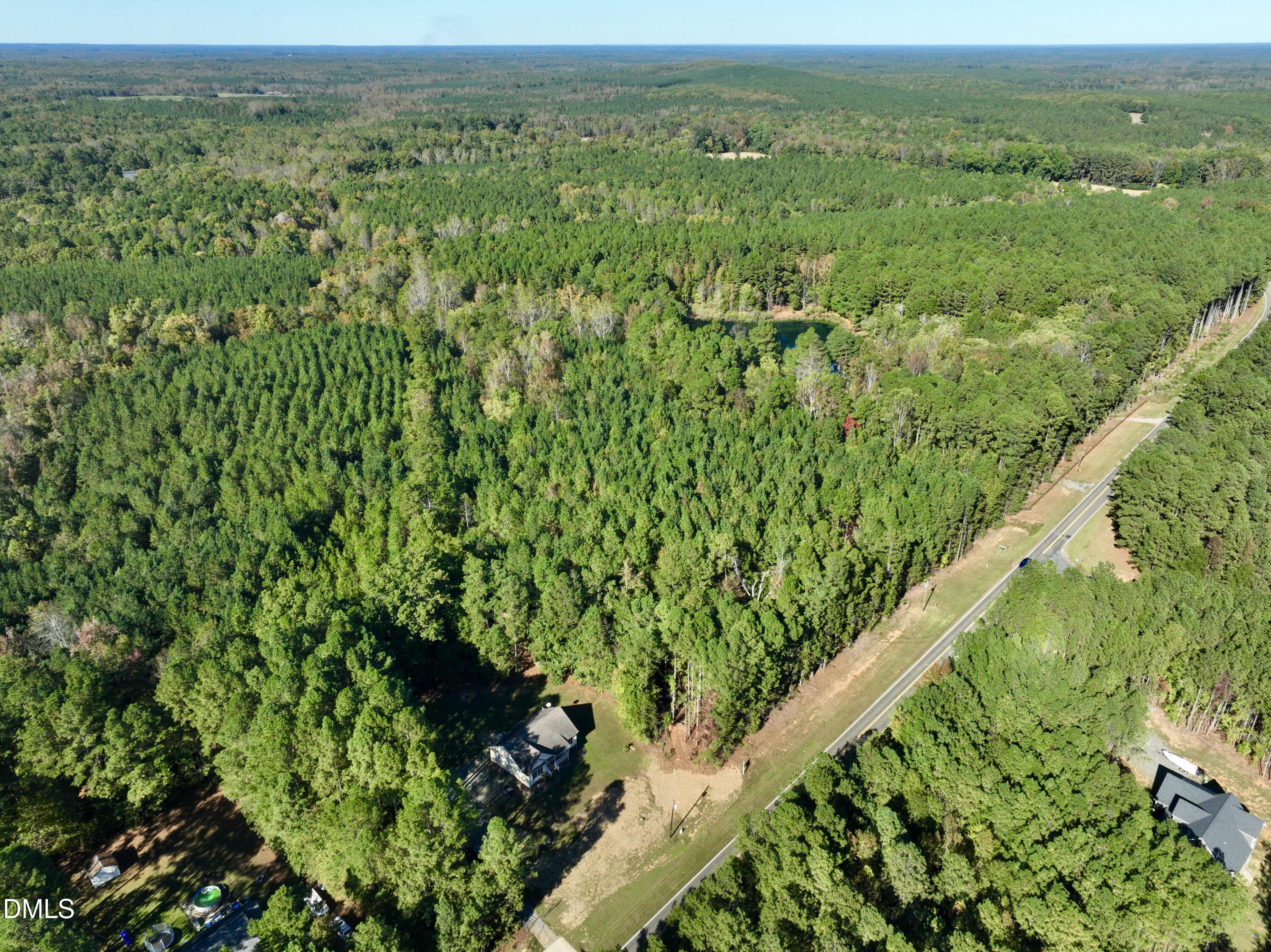 2097 Satterwhite Road Oxford, NC 27565 - Photo 39 of 40 a view of a green field with lots of bushes