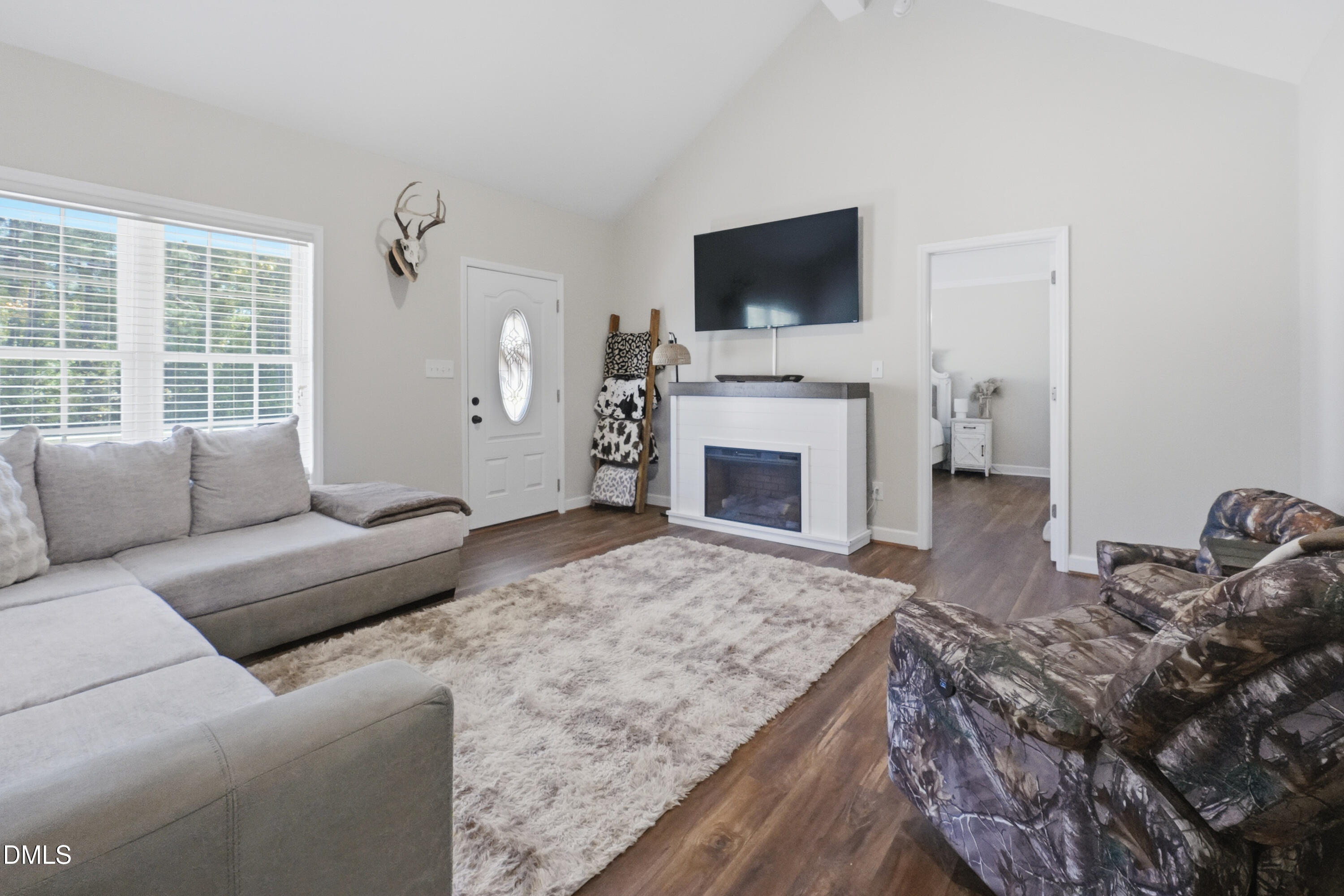 2097 Satterwhite Road Oxford, NC 27565 - Photo 6 of 40 a living room with furniture a fireplace and a flat screen tv
