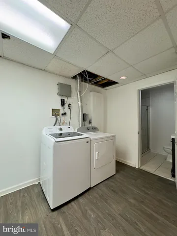 a utility room with sink dryer and washer