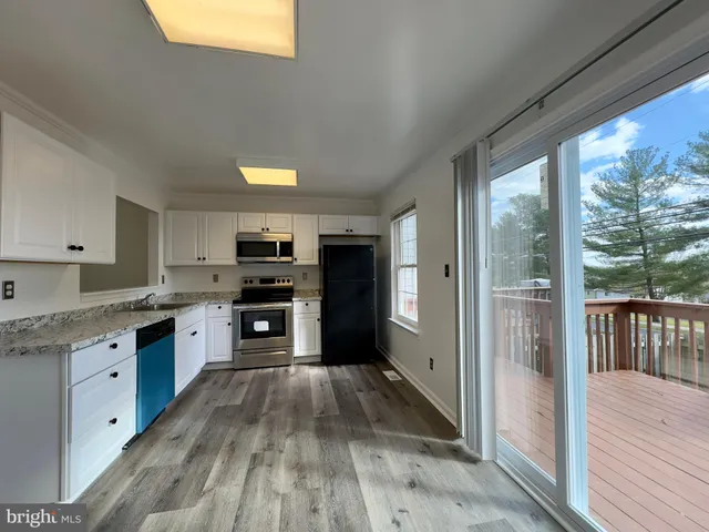 a kitchen with granite countertop a stove top oven and sink