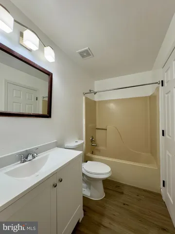 a bathroom with a sink toilet a mirror and shower