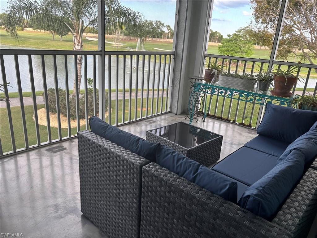 5928 Sand Wedge Lane, Unit 1808 Naples, FL 34110 - Photo 17 of 29 a view of a patio with a table chairs and a couch