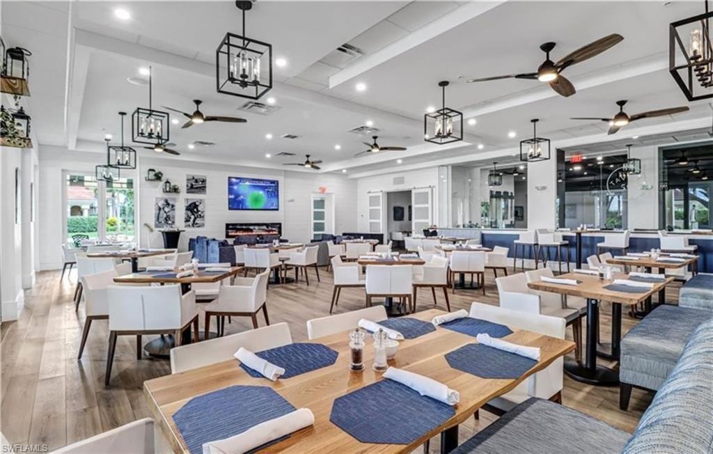 5928 Sand Wedge Lane, Unit 1808 Naples, FL 34110 - Photo 23 of 25 a living room with lots of furniture and kitchen view