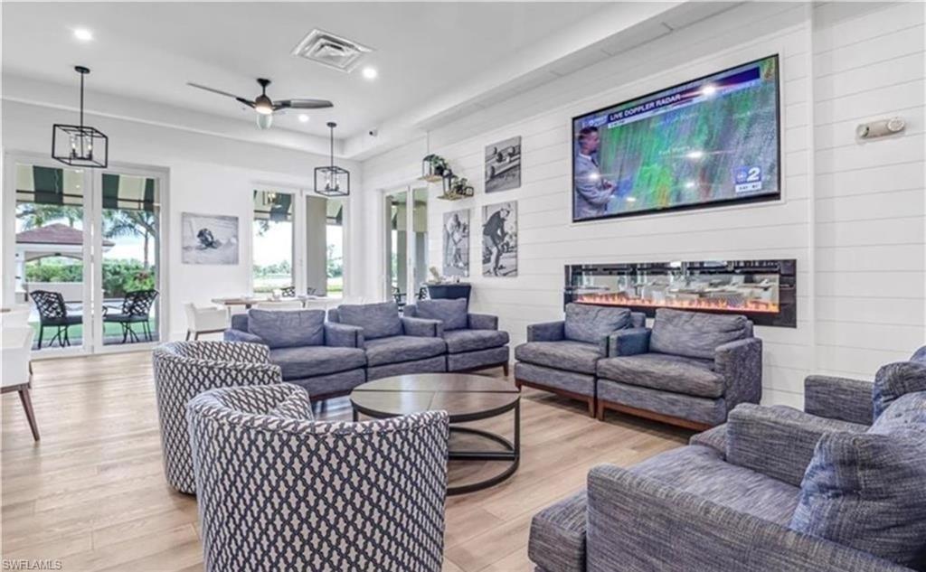 5928 Sand Wedge Lane, Unit 1808 Naples, FL 34110 - Photo 24 of 25 a living room with furniture and a painting