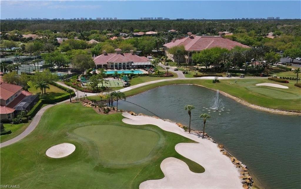 5928 Sand Wedge Lane, Unit 1808 Naples, FL 34110 - Photo 28 of 29 a view of a swimming pool with a yard and mountain view
