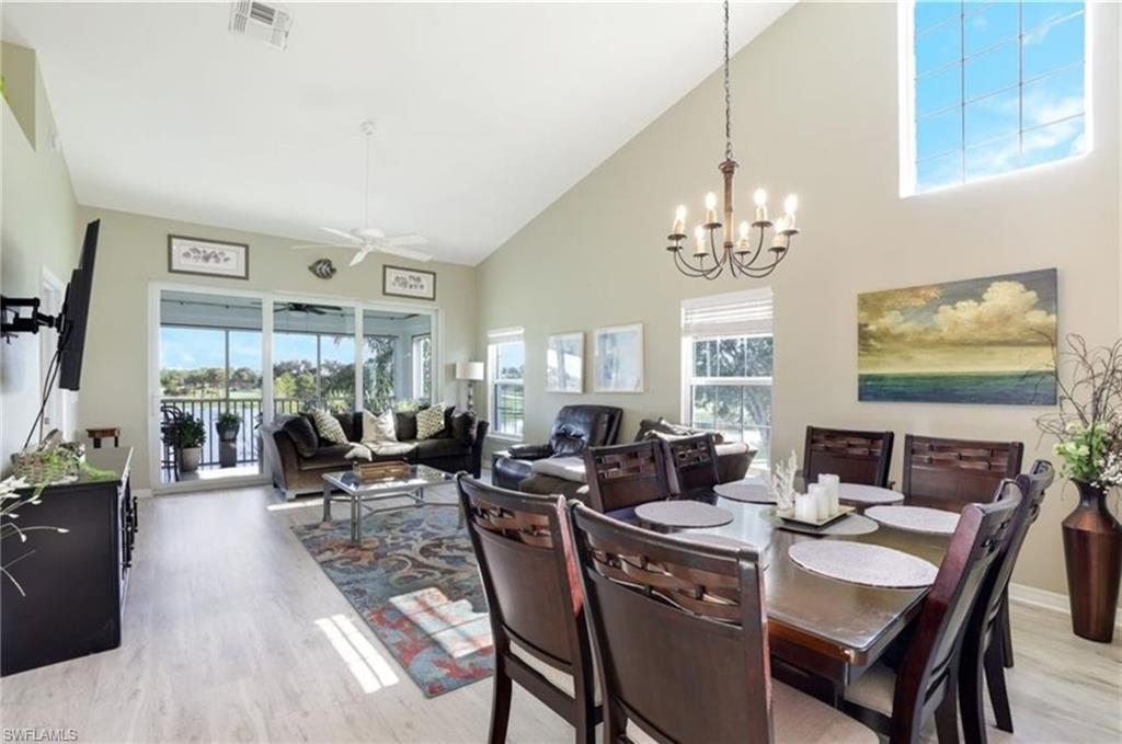 5928 Sand Wedge Lane, Unit 1808 Naples, FL 34110 - Photo 3 of 25 a view of a dining room with furniture window and outside view