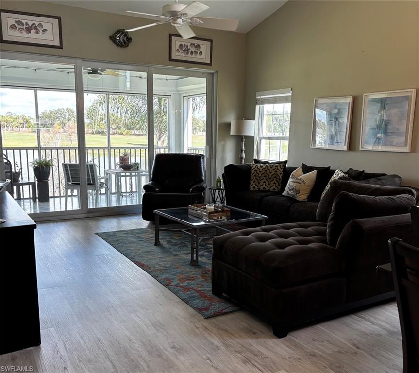 5928 Sand Wedge Lane, Unit 1808 Naples, FL 34110 - Photo 4 of 29 a living room with furniture and a large window