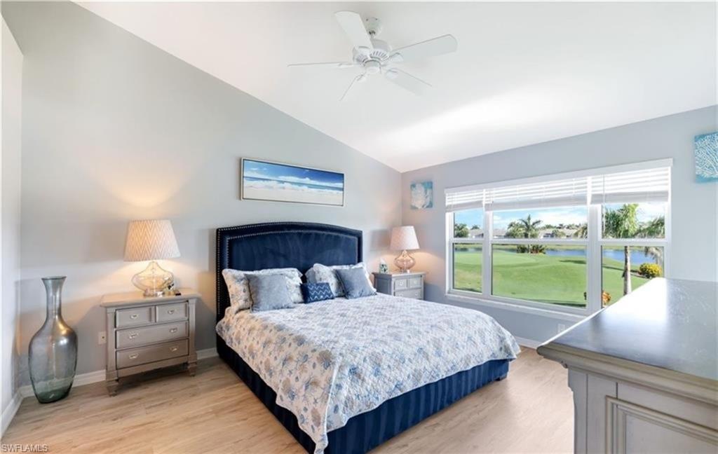 5928 Sand Wedge Lane, Unit 1808 Naples, FL 34110 - Photo 9 of 25 a bedroom with a bed and a large window with outer view