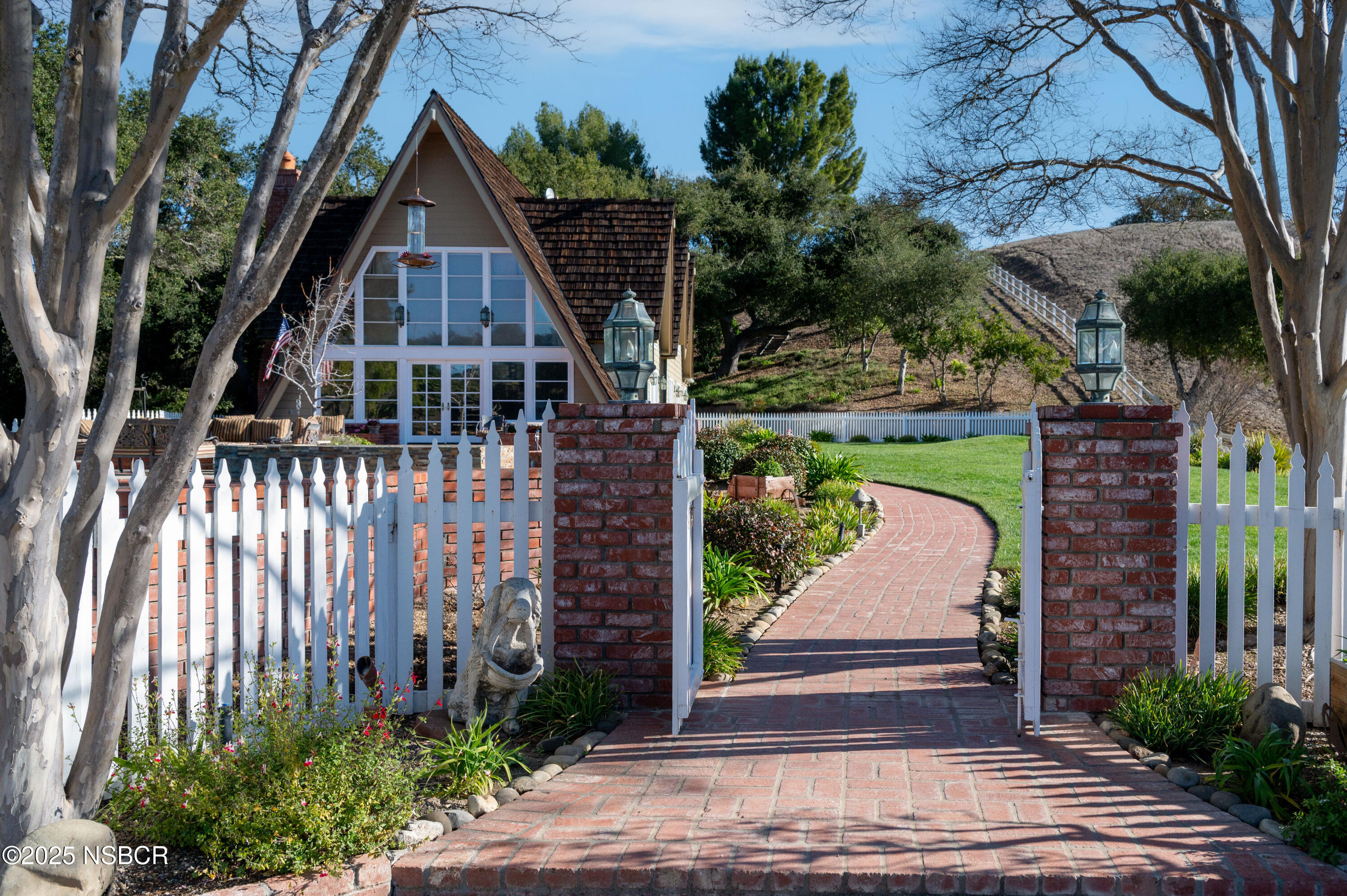 4086 East Oak Trail Road Santa Ynez, CA 93460 - Photo 5 of 57 a view of a brick house with a yard
