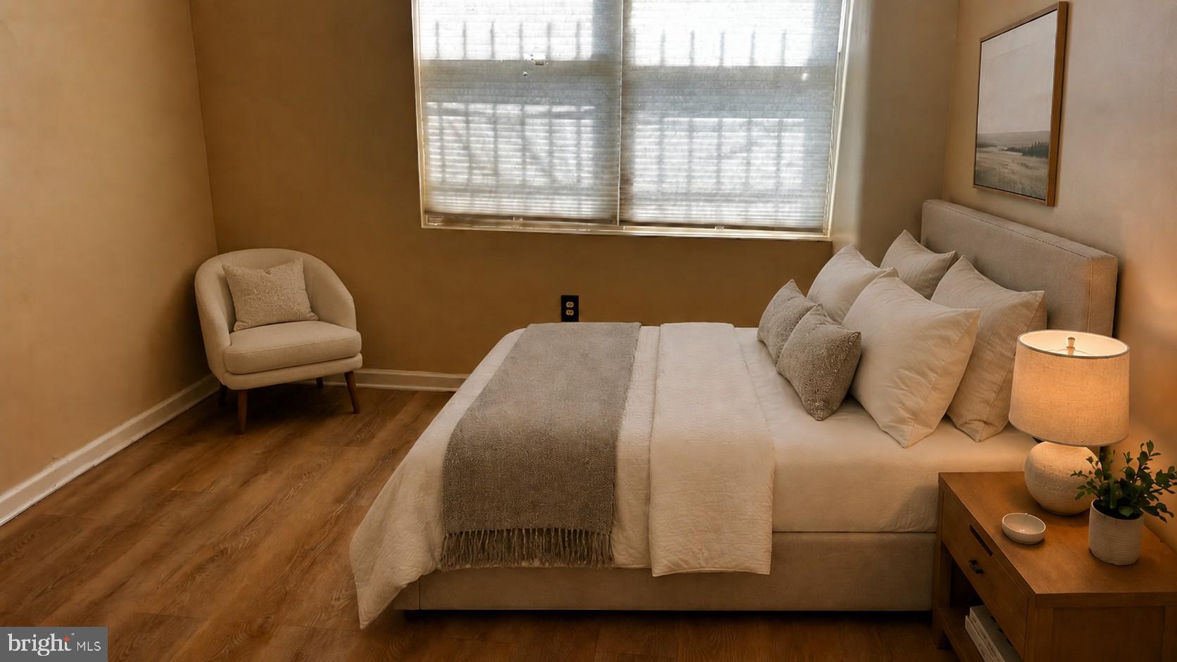 1240 18th Street Northeast, Unit 2 Washington, DC 20002 - Photo 7 of 11 a bedroom with a bed and a chair