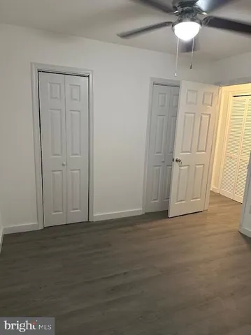 a kitchen with a stove top oven cabinets and a window