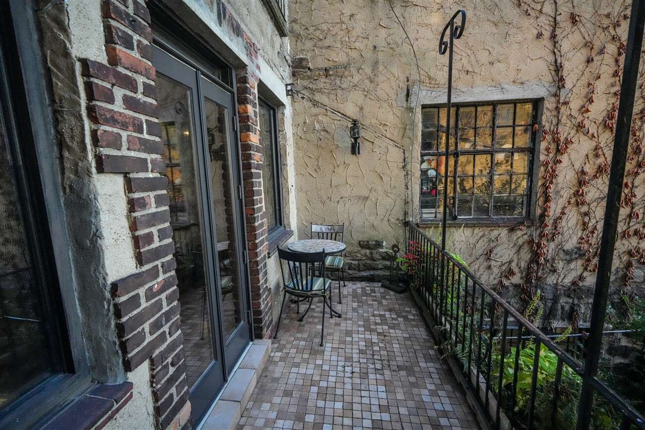 2501 Palisade Avenue, Unit G1 Bronx, NY 10463 - Photo 10 of 24 a view of a porch with a table and chairs and floor to ceiling window