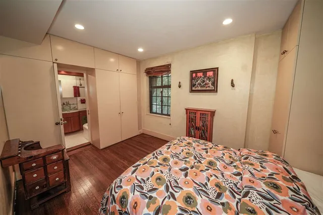 a bedroom with a bed and a dresser