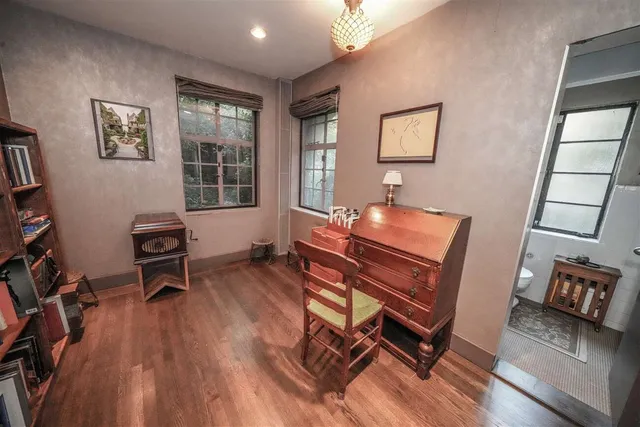 a room with wooden floor and windows