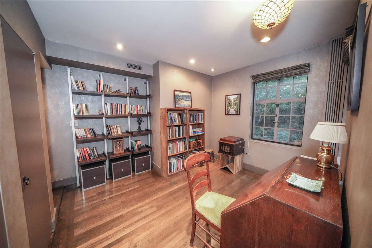 2501 Palisade Avenue, Unit G1 Bronx, NY 10463 - Photo 16 of 24 a living room with furniture a rug and a book shelf