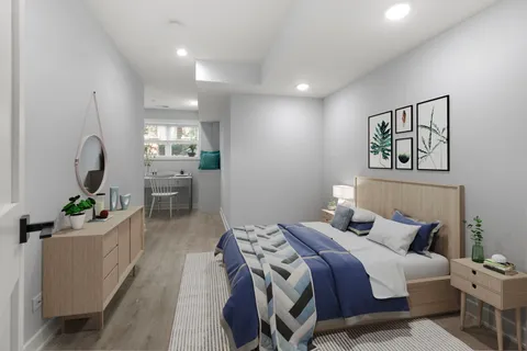 a bedroom with a bed window and couch