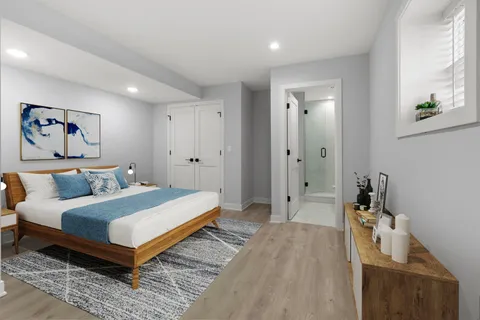 a bedroom with a bed and a painting on the wall