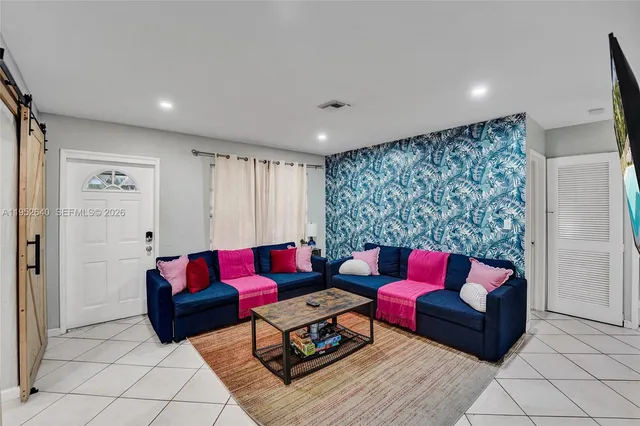a living room with furniture and a rug