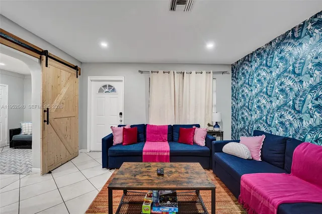 a living room with furniture and a rug