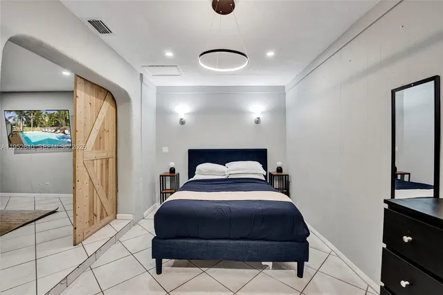 a bedroom with a bed and a dresser