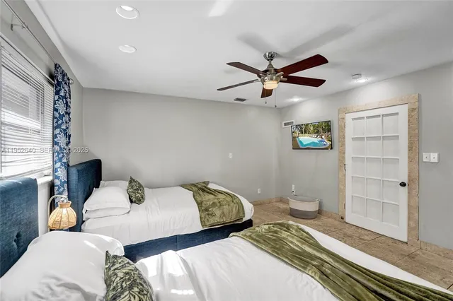 a bedroom with two beds and a walk in closet