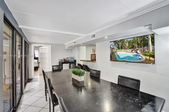 a view of a dining room with furniture and a floor to ceiling window