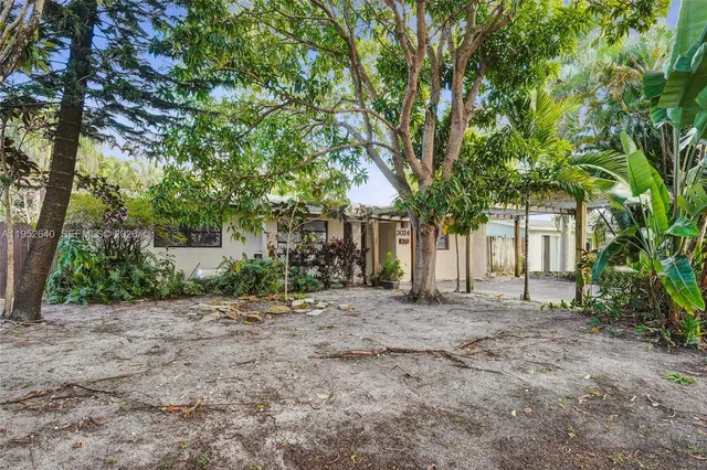 a view of a house with a tree in front