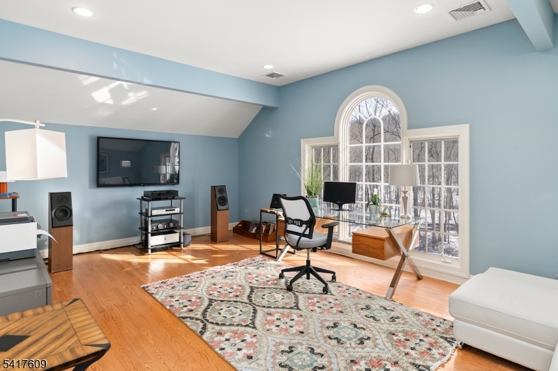 2 Cobblefield Road Mendham, NJ 07945 - Photo 25 of 50 a living room with furniture a flat screen tv and a table