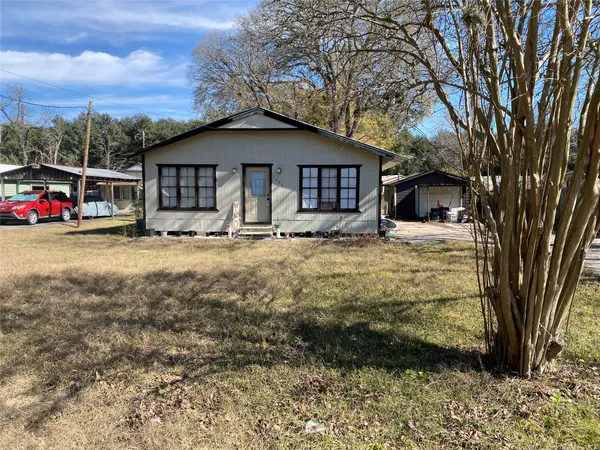 a view of a house with a yard and roof