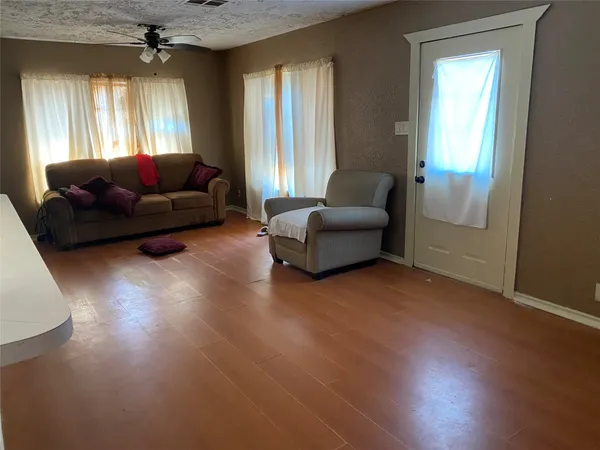 a living room with furniture a bed and a chandelier