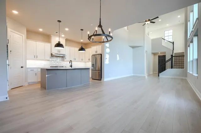 a view of a kitchen center island and stainless steel appliances
