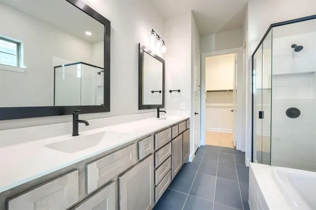 a bathroom with a double vanity sink and mirror with shower