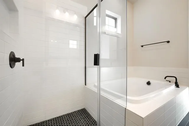 a bathroom with a bathtub and shower