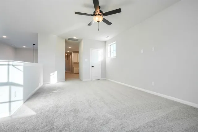 a view of a livingroom with a ceiling fan and window