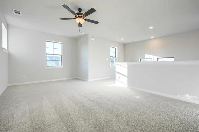 a view of a livingroom with a ceiling fan and window
