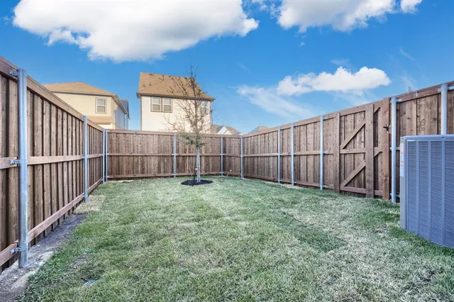 a view of a backyard with wooden fence