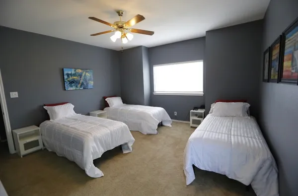 a bedroom with two beds and a chandelier