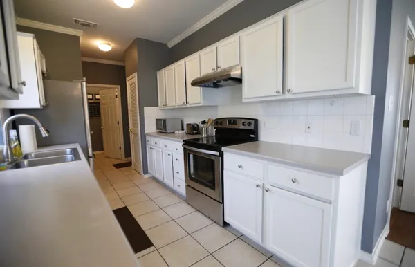 a kitchen with stainless steel appliances a refrigerator sink and cabinets