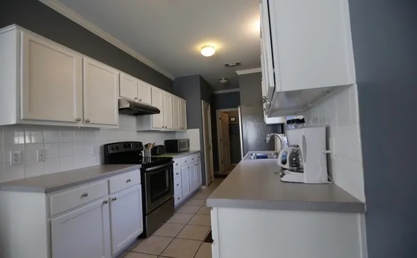 a kitchen with kitchen island a sink stainless steel appliances and cabinets