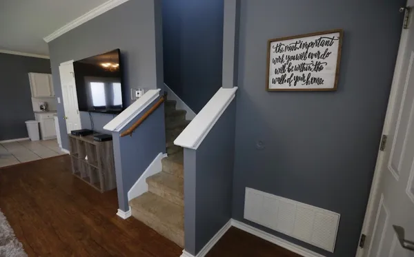 a view of entryway and hall with wooden floor