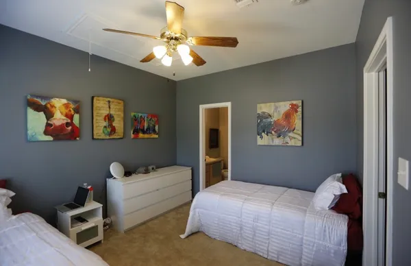 a bedroom with a bed and a chandelier
